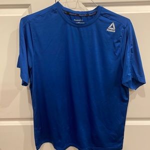 Short sleeve athletic Reebok shirt.